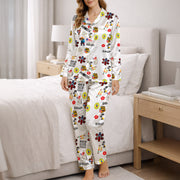 Women's pajama set featuring an all-over print design with Puerto Rican cultural elements including the flag, Taino sun, dominoes, coquito, palm trees, hibiscus, and various text phrases on soft silky satin fabric.