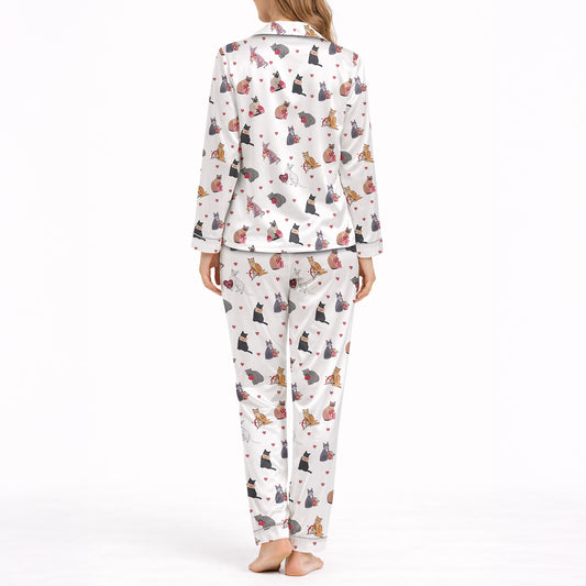 Women's pajama set with a cute cat and heart pattern on a white background, featuring various colored cats holding red hearts, perfect for pet lovers and cozy sleepwear.