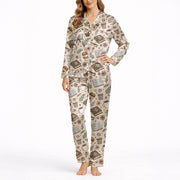 Women's short sleeve pajama set with a cozy pattern of books, coffee cups, eyeglasses, and flowers in warm brown and beige tones, perfect for reading and relaxation.