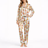 Women's pajama set featuring an all-over print of cute Golden Retrievers in various festive and seasonal outfits, on a white background.