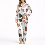 Women's white silky satin pajama set with an all-over Christmas print of curly-haired dogs wearing Santa hats and tangled in colorful string lights.