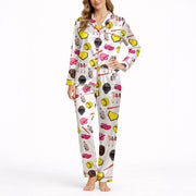 Women's pajama set featuring a white background with a colorful softball-themed pattern including softballs, bats, helmets, gloves, home plates, and female players.