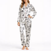 Women's pajama set featuring a black and white hand-drawn wedding doodle pattern with brides, grooms, cakes, rings, and champagne glasses on a white background, perfect for bridal loungewear.