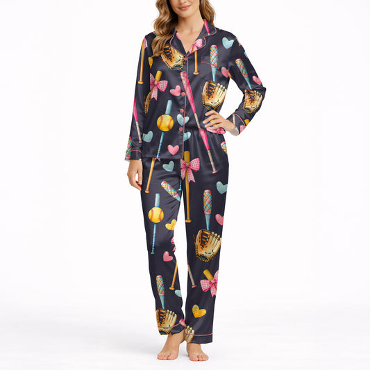Women's navy blue pajama set with a cute softball and baseball pattern featuring bats, gloves, softballs, hearts, and bows, made from soft knit fabric.
