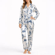 Women's pajama set with a blue sketch-style pattern of horses, horseshoes, and saddles on a white background, made from soft silky satin fabric.