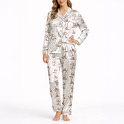 Women's cream pajama set with short sleeves and shorts, featuring a playful sepia-toned Dachshund dog print and small star accents.
