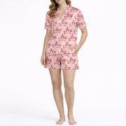 Women's pajama set with a fun pink pattern featuring cartoon dachshund dogs balancing martini glass towers, perfect for dog lovers and cocktail enthusiasts.