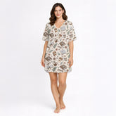 Women's short sleeve pajama set with a cozy pattern of books, coffee cups, eyeglasses, and flowers in warm brown and beige tones, perfect for reading and relaxation.