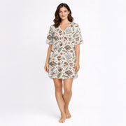 Women's short sleeve pajama set with a cozy pattern of books, coffee cups, eyeglasses, and flowers in warm brown and beige tones, perfect for reading and relaxation.