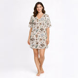 Women's short sleeve pajama set with a cozy pattern of books, coffee cups, eyeglasses, and flowers in warm brown and beige tones, perfect for reading and relaxation.