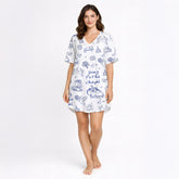 Women's short sleeve button down pajama set with shorts featuring a blue and white wedding doodle pattern including chapels, wedding cars, rings, doves, cakes, and 'Going To The Chapel' text.