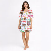 Women's pajama set with a vibrant white background, featuring an all-over print of diverse cartoon girls, pop art text like 'Gabriela' and 'Beautiful Chaos', and various symbols including anchors and crowns, creating a playful and eclectic collage pattern.