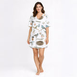 Women's short sleeve button down pajama set with shorts featuring a beautiful watercolor bird, nest, and egg pattern on white knit fabric.