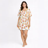Women's pajama set featuring an all-over print of cute Golden Retrievers in various festive and seasonal outfits, on a white background.