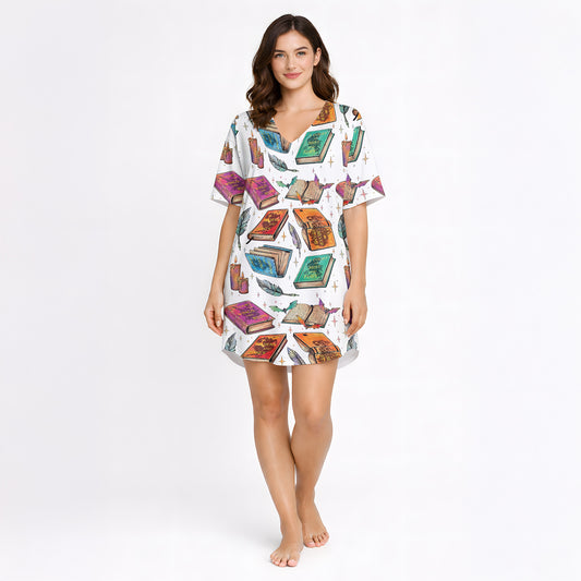 Women's pajama set featuring an 'Enchanted Library' print with colorful spellbooks, candles, and feathers, on a white background.