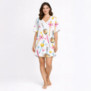 Women's pajama set featuring a cute watercolor print of pink and blue baseball bats, yellow softballs, brown gloves, and scattered hearts on a white background.