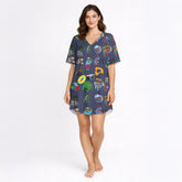 Women's pajama set with a vibrant Caribbean-themed pattern featuring Coquí frogs, Salsa hearts, Puerto Rico flag, coffee and rum drinks, palm trees, and cameras on a dark blue background.