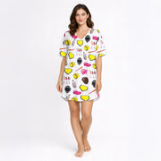 Women's pajama set featuring a white background with a colorful softball-themed pattern including softballs, bats, helmets, gloves, home plates, and female players.