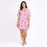 Pink pajama set with short sleeve button-down top and shorts, featuring an all-over cute bow pattern, perfect for women's sleepwear.