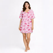 Pink pajama set with short sleeve button-down top and shorts, featuring an all-over cute bow pattern, perfect for women's sleepwear.