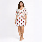Women's pajama set featuring a festive pattern of espresso martinis with Santa hats and red bows, surrounded by coffee beans on a white background.
