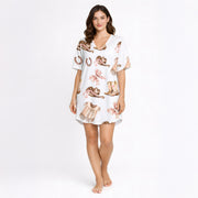 Women's pajama set featuring a charming Western-themed watercolor pattern with cowboy boots, hats, vests, horseshoes, and pink plaid bows on a white background.