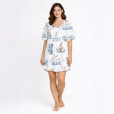 Women's white pajama set featuring a charming blue and white watercolor bunny and Easter egg pattern, with rabbits, delicate floral elements, and vintage-style carts, perfect for spring sleepwear.