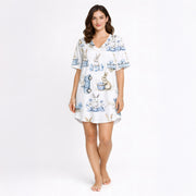 Women's white pajama set featuring a charming blue and white watercolor bunny and Easter egg pattern, with rabbits, delicate floral elements, and vintage-style carts, perfect for spring sleepwear.