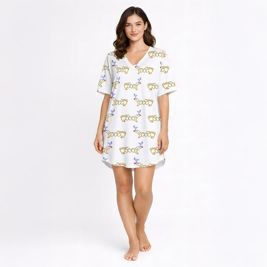 White pajama set with short sleeve button down top and shorts, featuring a playful pattern of cartoon dachshund dogs, some holding blue martini glasses, and the word 'GOOD' stylized as a dog, with green piping.