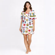 Woman wearing a white long-sleeve button-down pajama set with a colorful, all-over print featuring Puerto Rican cultural symbols like the flag, Coqui frog, Vejigante mask, and 'I love PR' text. The pajamas are made of soft knit fabric.