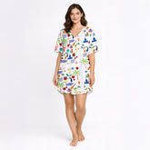 Women's pajama set featuring a vibrant Puerto Rico themed print with the flag, coqui frogs, palm trees, hibiscus flowers, and El Morro, on a white background.
