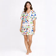 Women's pajama set featuring a vibrant Puerto Rico themed print with the flag, coqui frogs, palm trees, hibiscus flowers, and El Morro, on a white background.