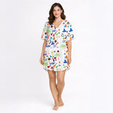 Women's pajama set featuring a vibrant Puerto Rico themed print with the flag, coqui frogs, palm trees, hibiscus flowers, and El Morro, on a white background.