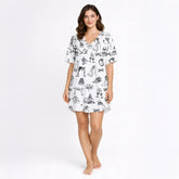 Women's pajama set featuring a black and white hand-drawn wedding doodle pattern with brides, grooms, cakes, rings, and champagne glasses on a white background, perfect for bridal loungewear.
