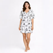 Women's pajama set featuring a black and white hand-drawn wedding doodle pattern with brides, grooms, cakes, rings, and champagne glasses on a white background, perfect for bridal loungewear.