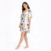 Women's pajama set featuring an all-over print design with Puerto Rican cultural elements including the flag, Taino sun, dominoes, coquito, palm trees, hibiscus, and various text phrases on soft knit fabric.