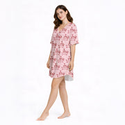 Women's pajama set with a fun pink pattern featuring cartoon dachshund dogs balancing martini glass towers, perfect for dog lovers and cocktail enthusiasts.