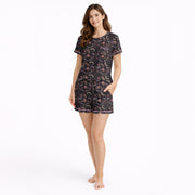 Women's short sleeve button down pajama set with shorts featuring a dark celestial and botanical print of moths, crescent moons, and pink flowers on a black background.