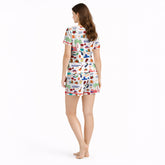 Women's pajama set featuring a vibrant Puerto Rico themed pattern with flags, coqui frogs, palm trees, and musical instruments on a white background.