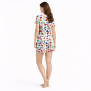 Women's pajama set featuring a vibrant Puerto Rico themed pattern with flags, coqui frogs, palm trees, and musical instruments on a white background.