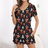 Women's Christmas pajama set featuring a festive pattern of cute Highland cows wearing Santa hats and plaid scarves, with white Christmas trees and snowflakes on a black background. The set includes a short-sleeve button-down top and matching shorts.