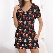Women's Christmas pajama set featuring a festive pattern of cute Highland cows wearing Santa hats and plaid scarves, with white Christmas trees and snowflakes on a black background. The set includes a short-sleeve button-down top and matching shorts.