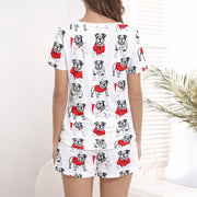 Women's pajama set with a repeating pattern of cute cartoon bulldogs wearing red sweaters on a white background, perfect for dog lovers.