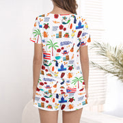 Women's pajama set featuring a vibrant Puerto Rico themed pattern with flags, coqui frogs, palm trees, and musical instruments on a white background.