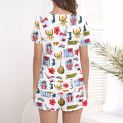 Women's knit pajama set featuring a vibrant Puerto Rican cultural pattern with coqui frogs, hibiscus, coconuts, and 'I Love PR' text, perfect for comfortable loungewear.