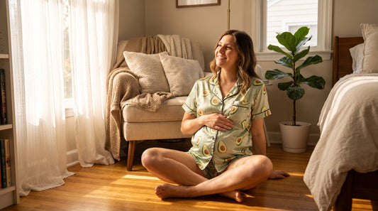 Pregnant woman wearing comfortable avocado pajamas in sunny bedroom