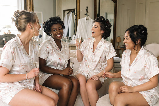 Bridesmaids wearing matching sweatpants and tank top sets while getting ready for wedding
