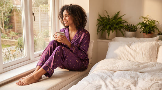 Woman wearing fantasy print two piece set for summer in cozy bedroom setting