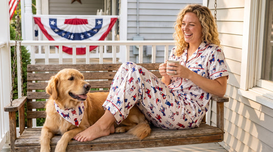 Woman wearing patriotic dog print pajama set coordinating with her dog on 4th of July porch