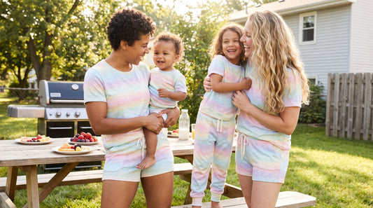 Queer family wearing Pride rainbow AOP matching sets for moms and kids in summer
